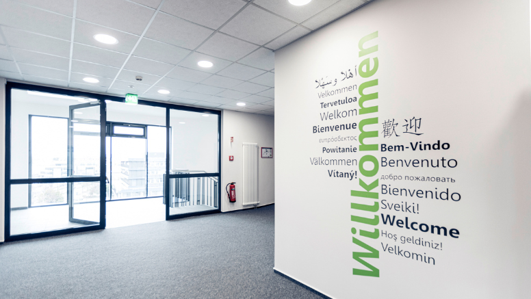 Im Erdgeschoss des Jobcenters werden die Besucherinnen und Besucher mehrsprachig „Willkommen“ geheißen.