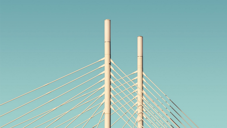 Zwei weiße Brückenpfeiler vor hellblauem Himmel.Öffnet Seite: Hintergrundbericht